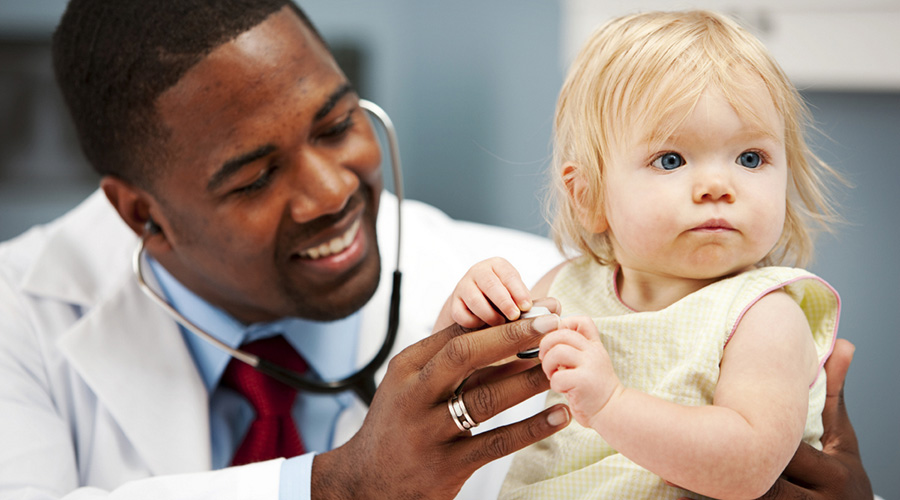 African American doctor holding a baby